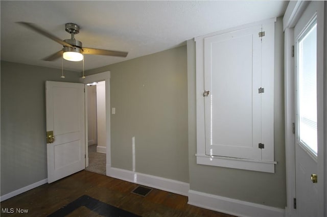 interior space with ceiling fan and dark hardwood / wood-style floors