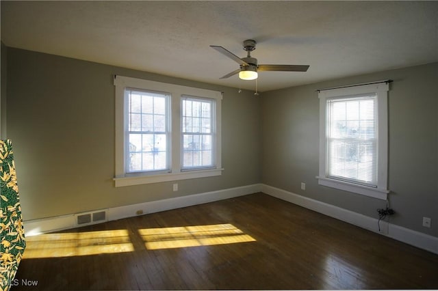 unfurnished room featuring ceiling fan and dark wood-type flooring