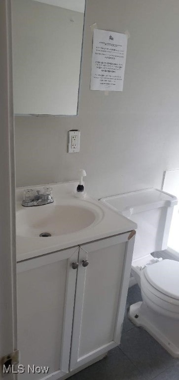 bathroom with tile patterned floors, vanity, and toilet