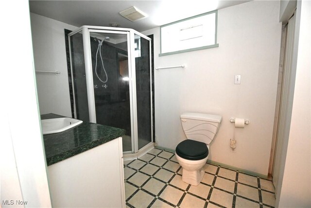 bathroom with vanity, toilet, and walk in shower