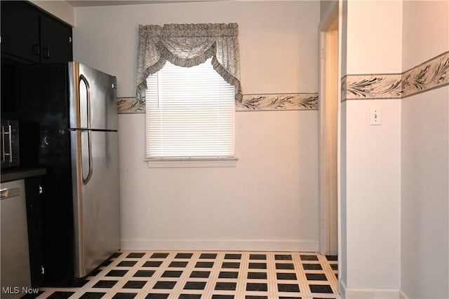 kitchen with tile patterned flooring and appliances with stainless steel finishes