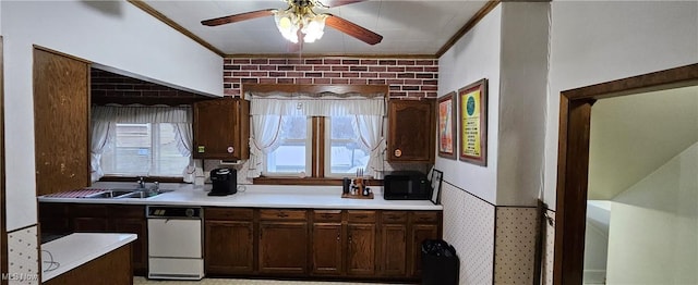 kitchen with crown molding, sink, ceiling fan, and brick wall