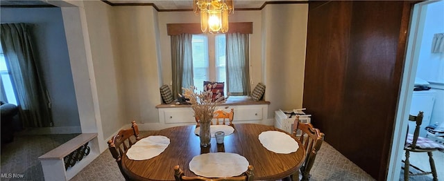 dining space featuring ornamental molding and an inviting chandelier