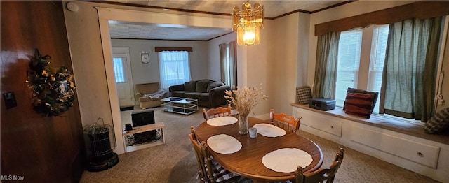 dining room with carpet flooring, plenty of natural light, and ornamental molding