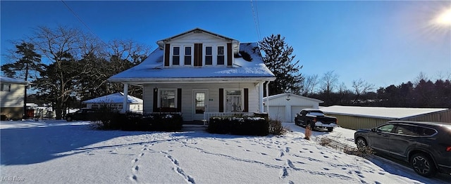 view of front of home with an outbuilding, a garage, and covered porch