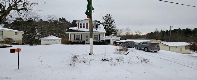 view of front of property featuring a garage and an outdoor structure