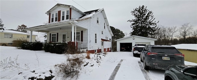 view of front of house with a porch, a garage, and an outdoor structure