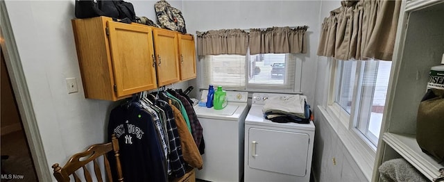 washroom featuring washer and dryer, plenty of natural light, and cabinets