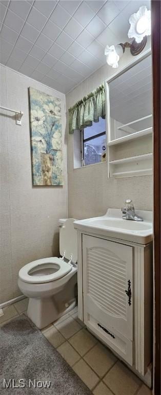 bathroom featuring tile patterned flooring, vanity, and toilet