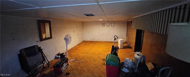 basement with a paneled ceiling