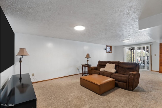 carpeted living room featuring a textured ceiling