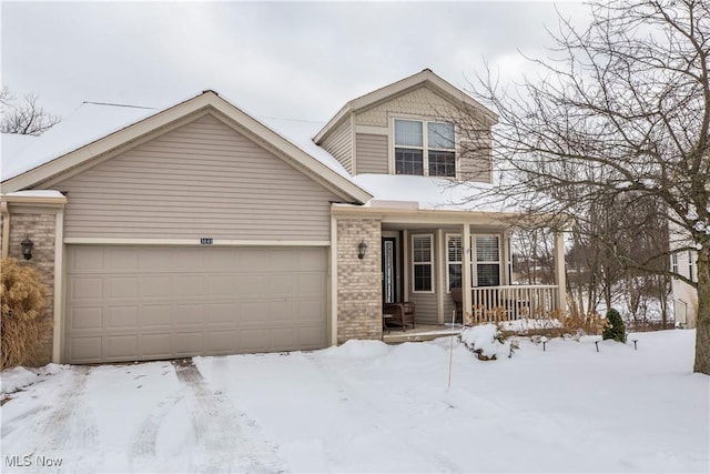 view of front property with a porch and a garage