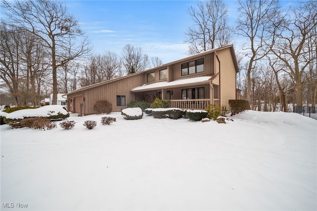 view of front of property featuring covered porch and a garage