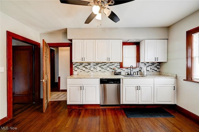 kitchen featuring dishwasher, sink, tasteful backsplash, dark hardwood / wood-style flooring, and white cabinetry