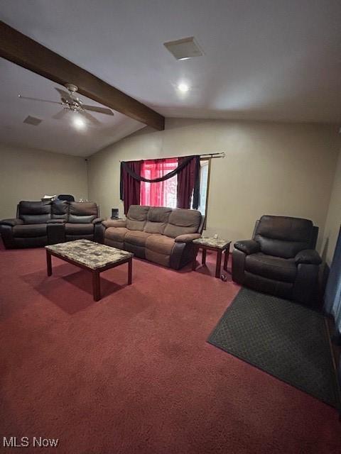 carpeted living room with ceiling fan and lofted ceiling with beams