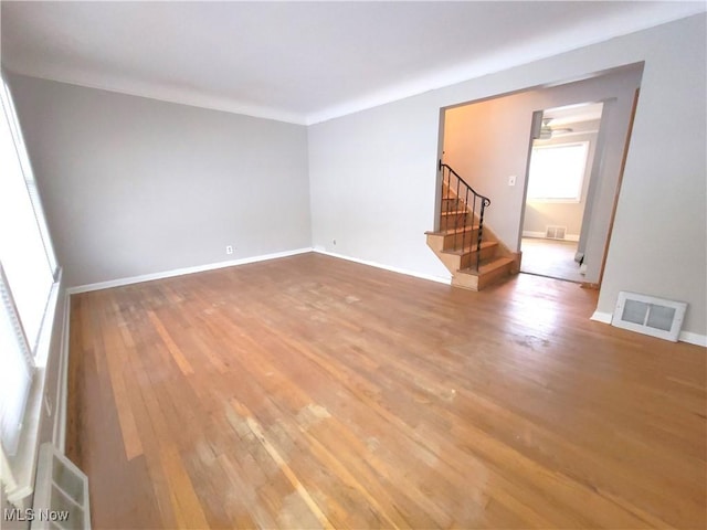 empty room featuring crown molding and wood-type flooring