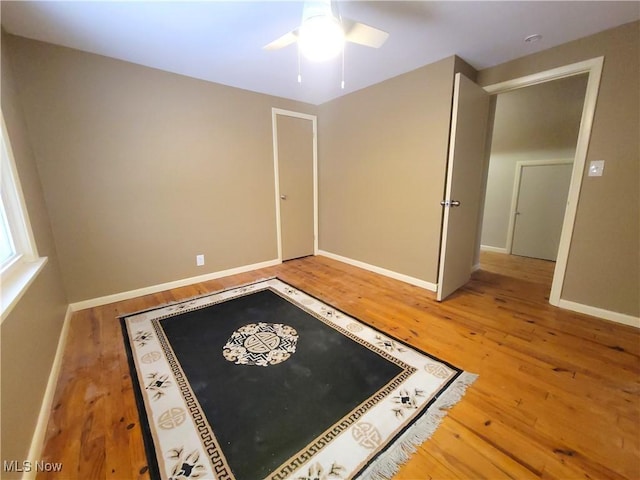 interior space featuring wood-type flooring and ceiling fan