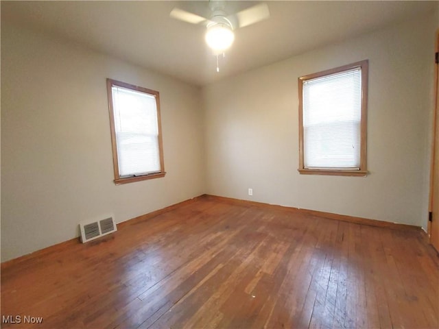 spare room featuring ceiling fan and hardwood / wood-style floors