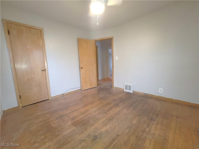 unfurnished room featuring hardwood / wood-style flooring