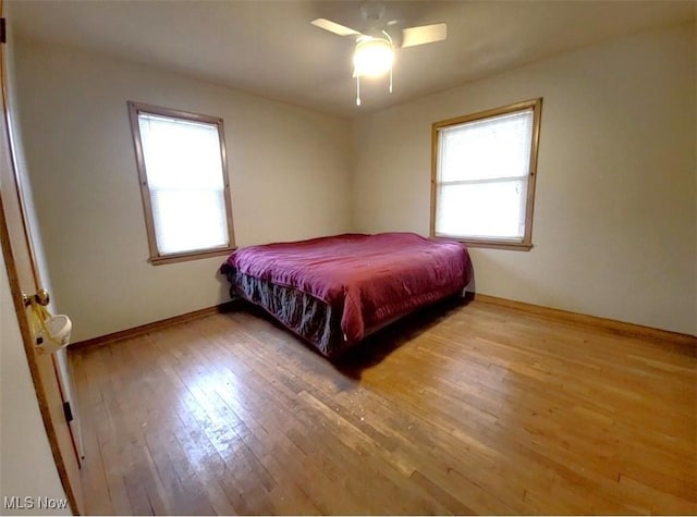 bedroom with wood-type flooring and ceiling fan