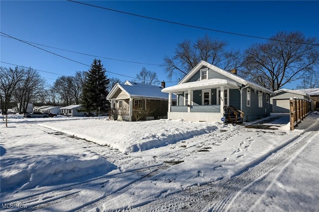 view of front facade featuring an outdoor structure and a garage