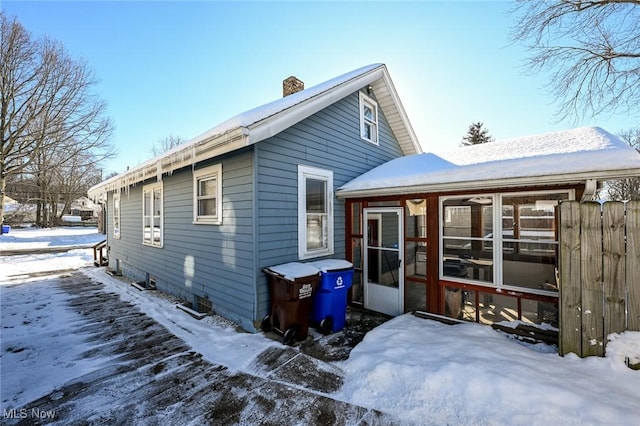 view of snow covered rear of property