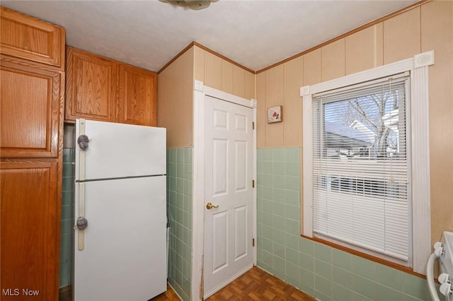 kitchen featuring dark parquet flooring, stove, and white refrigerator