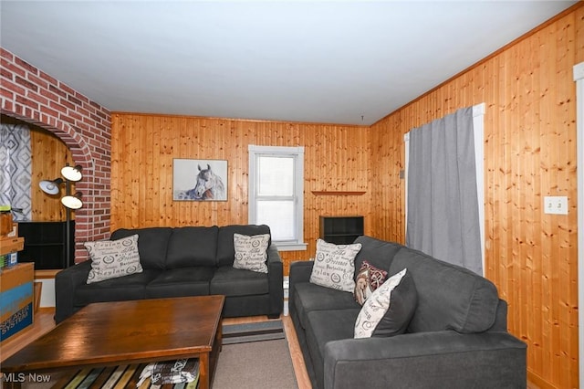 living room featuring carpet and wooden walls