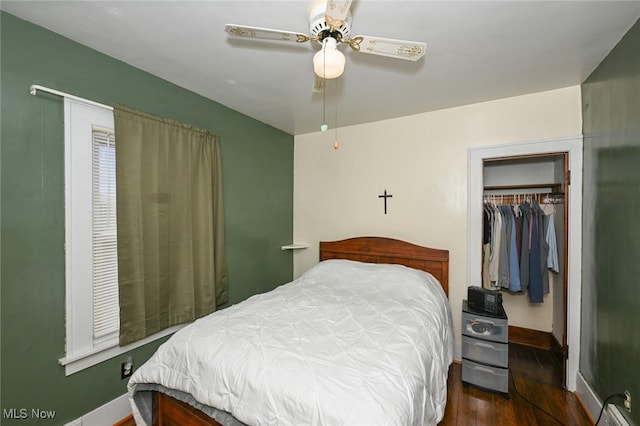 bedroom with dark hardwood / wood-style flooring, a closet, and ceiling fan