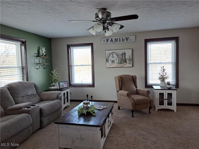 carpeted living room featuring a textured ceiling, plenty of natural light, and ceiling fan