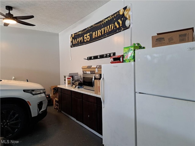 garage featuring ceiling fan and white fridge