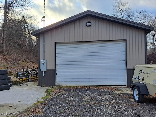 view of garage at dusk