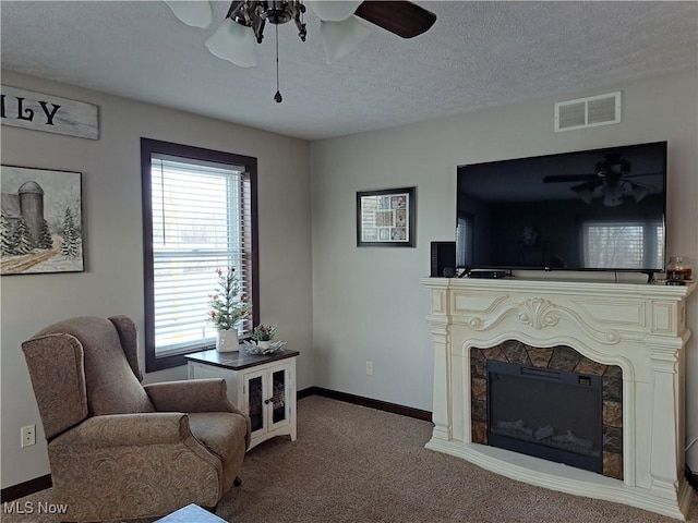 living room featuring carpet floors and a textured ceiling