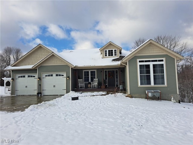 view of front of property featuring covered porch and a garage