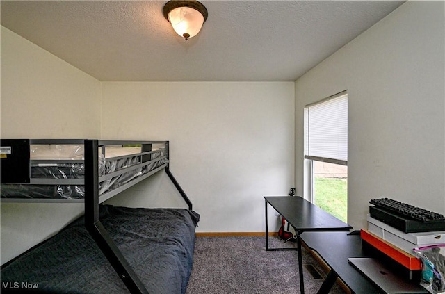 bedroom with carpet floors and a textured ceiling