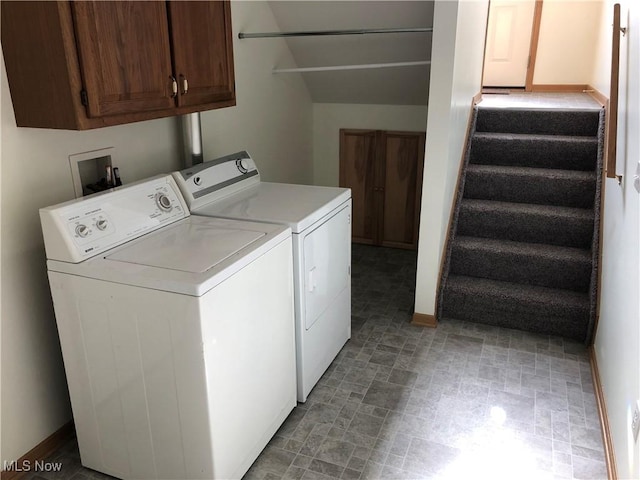 washroom featuring cabinets and independent washer and dryer