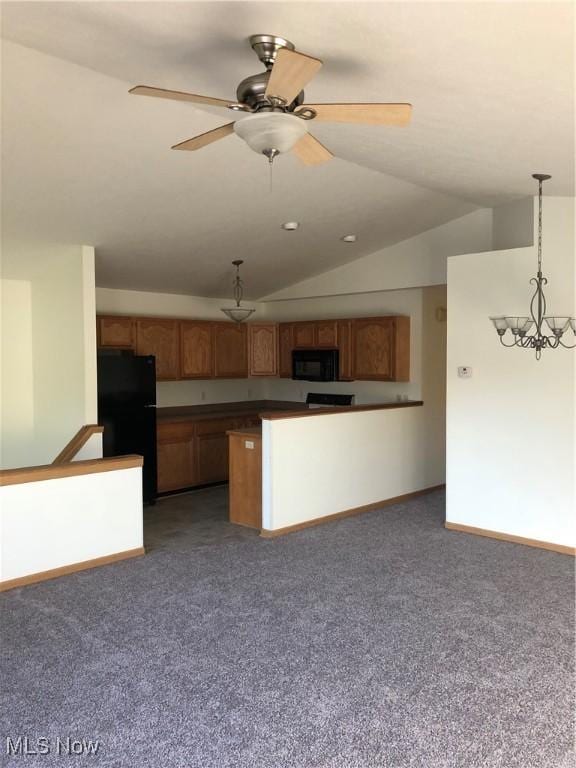 kitchen featuring dark carpet, lofted ceiling, decorative light fixtures, black appliances, and ceiling fan with notable chandelier