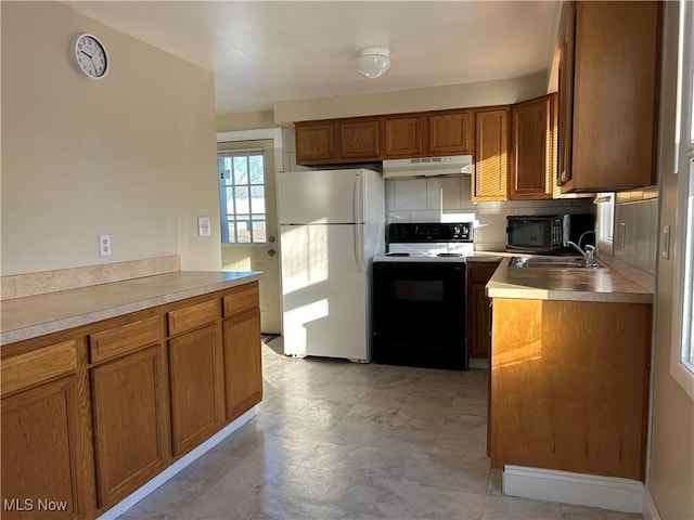 kitchen featuring decorative backsplash, white appliances, and sink