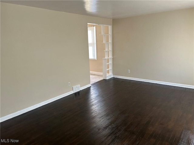 unfurnished room featuring dark hardwood / wood-style flooring