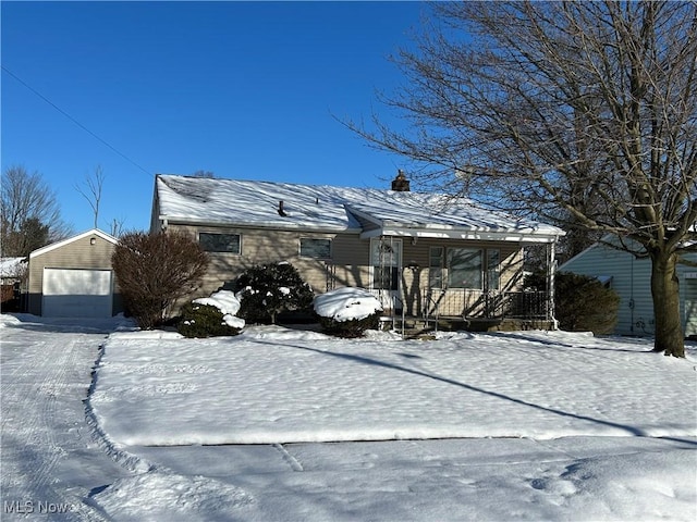 view of front of house with covered porch, a garage, and an outdoor structure