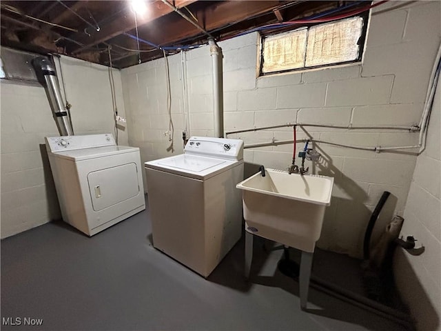 laundry room with washing machine and dryer and sink