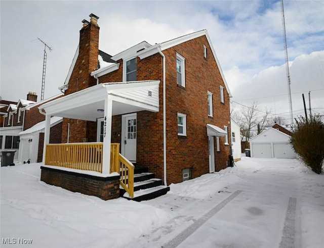 view of front of home with a garage and an outdoor structure