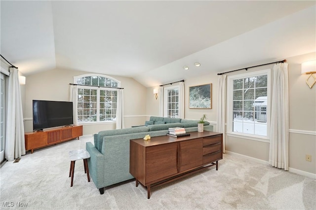 living room with light colored carpet, vaulted ceiling, and a wealth of natural light