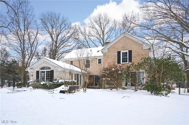 view of snow covered back of property