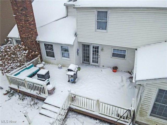 view of snow covered rear of property