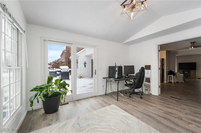 office area with hardwood / wood-style flooring and vaulted ceiling