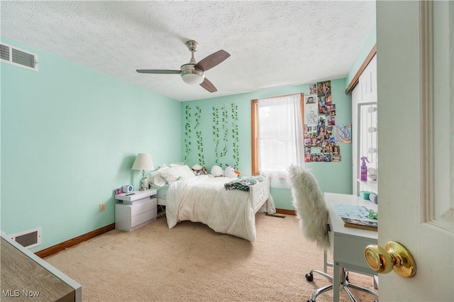 carpeted bedroom featuring ceiling fan, a textured ceiling, and a closet