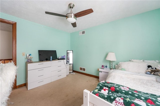 carpeted bedroom featuring a textured ceiling and ceiling fan