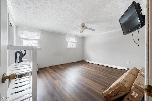 interior space featuring ceiling fan, dark wood-type flooring, a textured ceiling, and ornamental molding