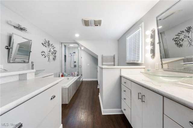 bathroom with independent shower and bath, vanity, and wood-type flooring